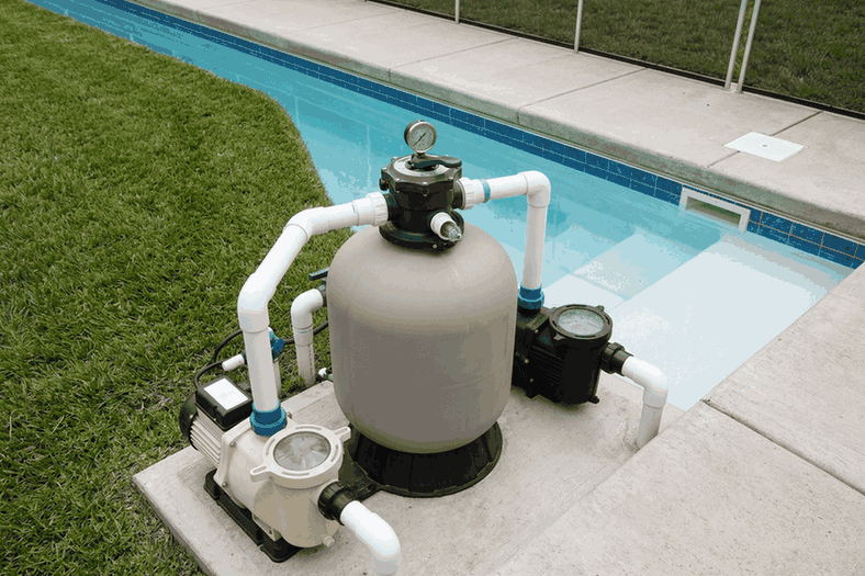 Pool sand filter with its pressure gauge on top, next to the pump on the equipment pad